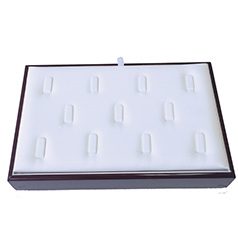 A white tray with 1 2 rings on top of it.