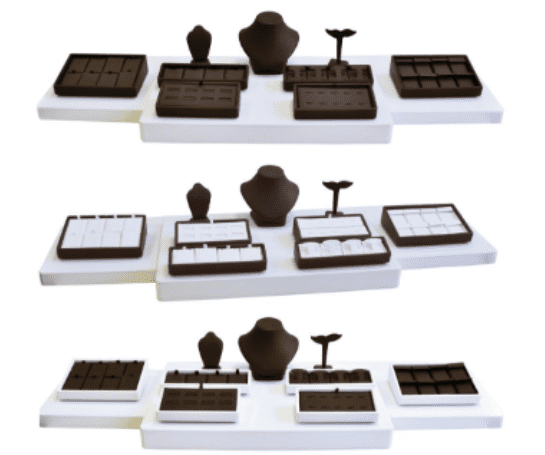 A set of three trays with different types of jewelry.