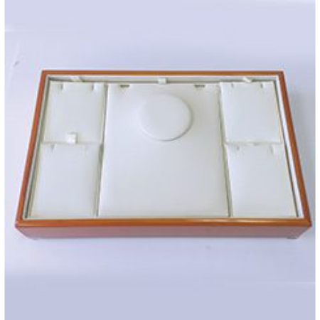 A white box with brown trim and a round hole.