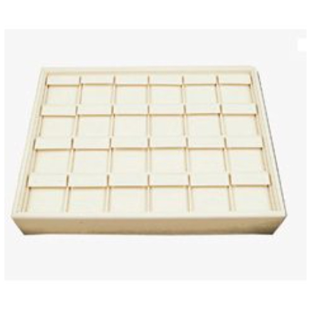 A white tray with many small boxes on top of it.