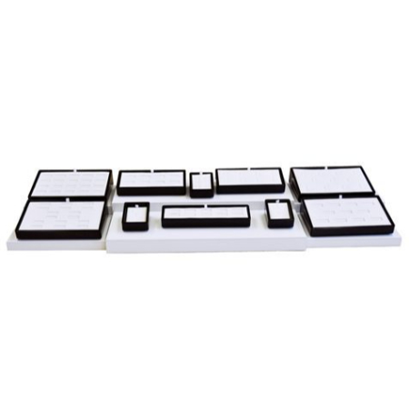 A white tray with black trim and various shapes.