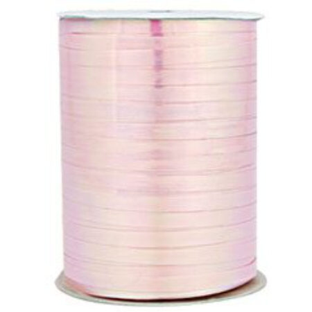 A roll of pink ribbon on top of a white table.